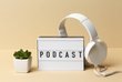Kopfhörer, Pflanze und der Schriftzug "Podcast"